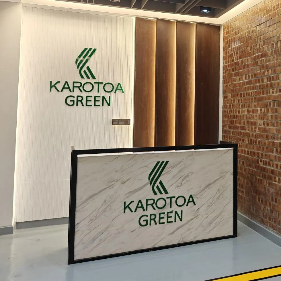 Karotoa Green corporate reception desk with company logo and modern interior design.