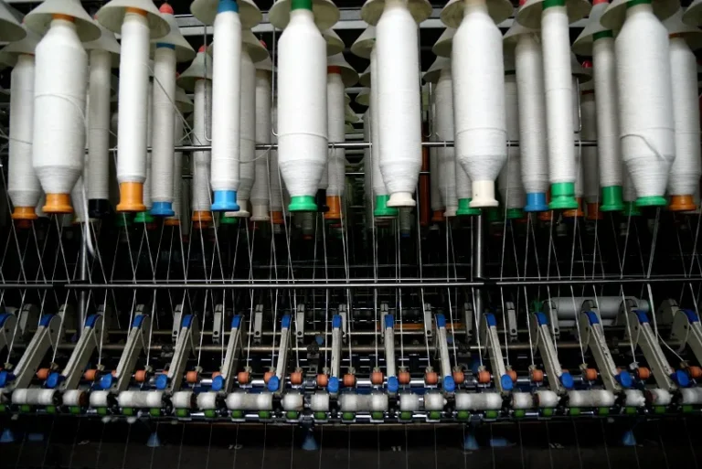 Karotoa Green spinning frame machine producing cotton yarn inside textile manufacturing facility.