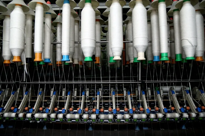 Karotoa Green spinning frame machine producing cotton yarn inside textile manufacturing facility.